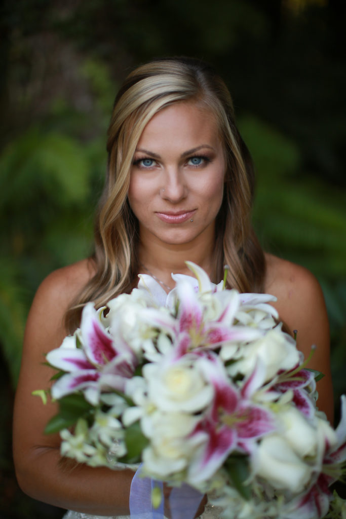 The bride holding her bouquet close to her face for a serene photo.