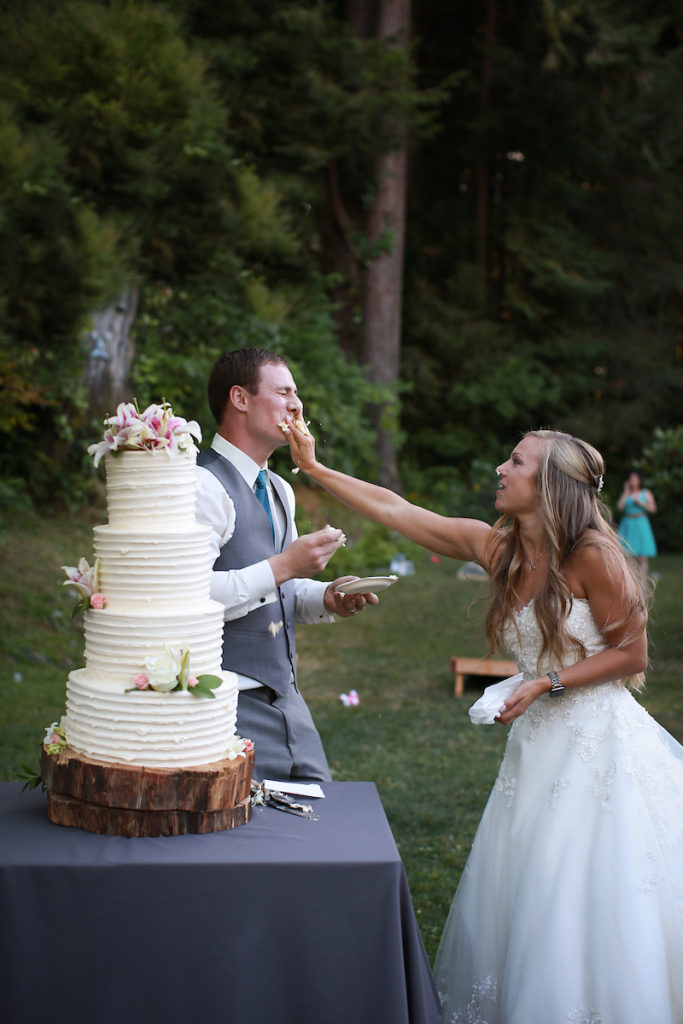 The bride smashing cake into the groom's mouth.