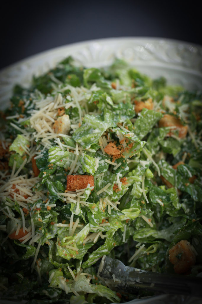 A close up photo of a Caesar salad served at the reception.