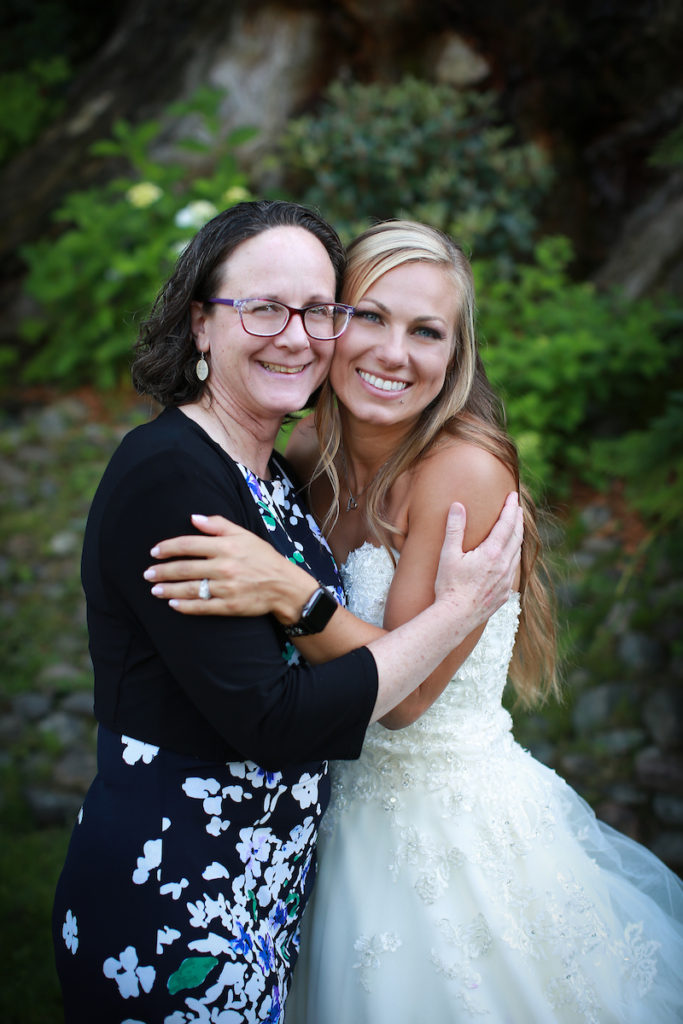 The bride embracing a family member for a photo.