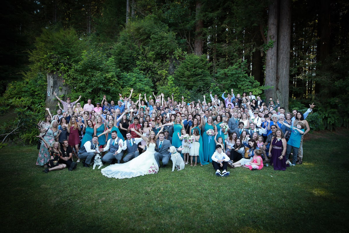 All of the guests of the wedding, including the wedding party, pose for a fun photo.